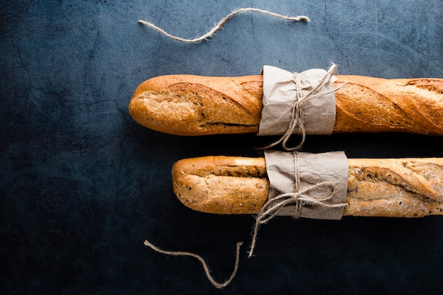 Top view of baguettes on black background