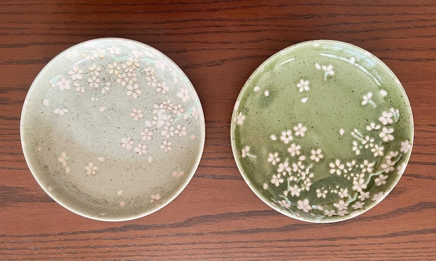 Top view of beautiful crockery set with porcelain ceramic plate\
round dish isolated on table background