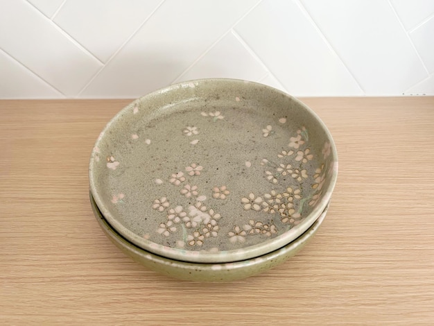 Top view of beautiful crockery set with porcelain ceramic plate\
round dish isolated on table background