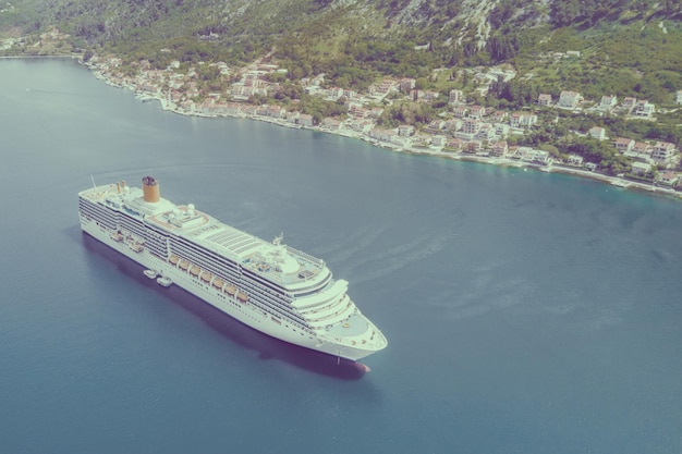 Top view of a beautiful cruise liner floating by the city Toned