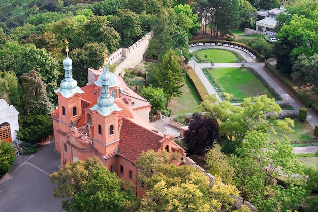 Top view of a beautiful red ancient castle among the green trees