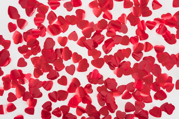 Top view of beautiful red heart shaped petals on grey background valentines day concept