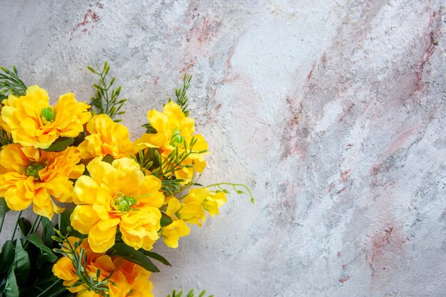 top view beautiful yellow flowers on white surface