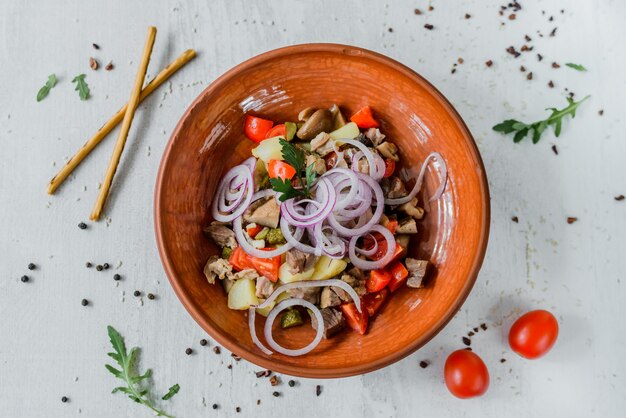 Top view on beef salad in ceramic bowl