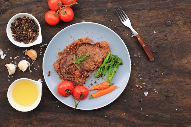 Top view of Beef steaks with rosemary and roast vegetables, food meat or barbecue