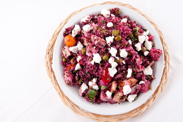 Top view of beet salad with quinoa and chicken