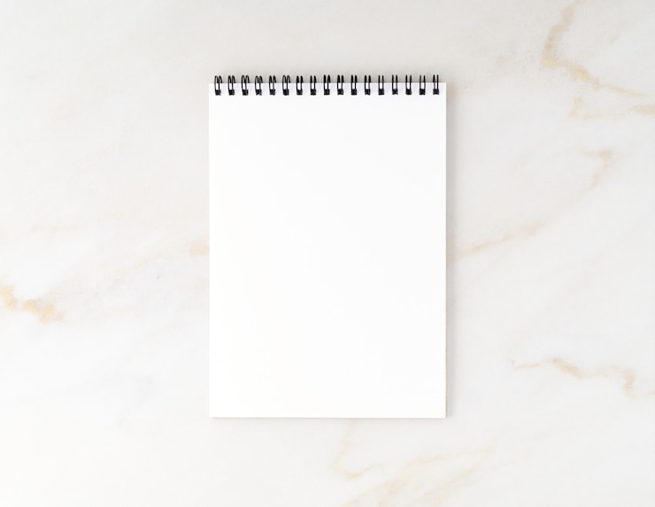 Photo top view of beige marble desktop with notepad. mock up, empty space