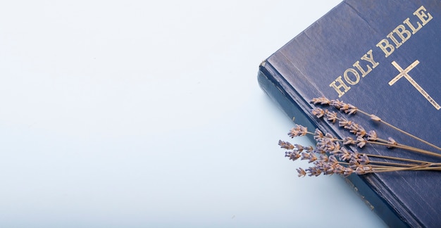 Top view of bible and dry lavender flowers with copy space