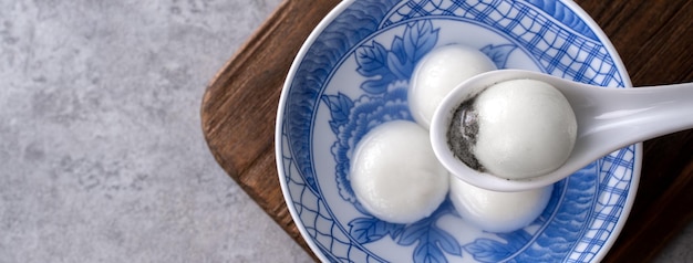 Top view of big tangyuan yuanxiao in a bowl on gray background for lunar new year food