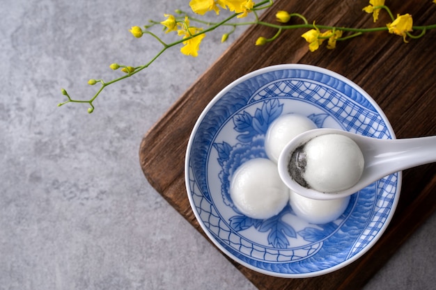 Top view of big tangyuan yuanxiao (glutinous rice dumpling balls) for lunar new year festival food, words on the golden coin means the Dynasty name it made.