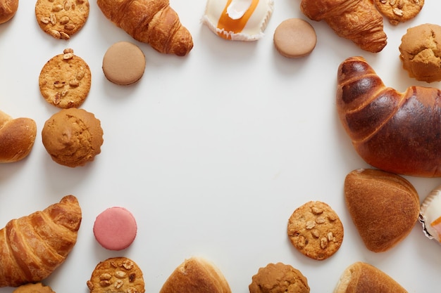 Top view of big variety of sweets on table with empty space in the middle Free space for advertisement promotional text