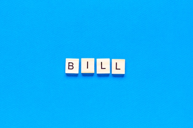 Top view bill written with wooden letters