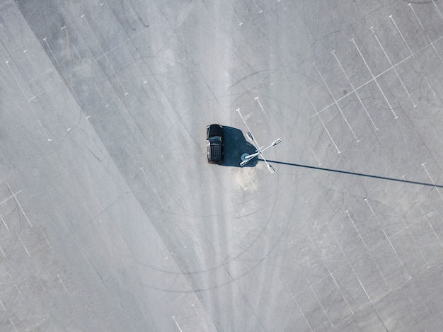 Top above view  black car running on blank empty asphalt