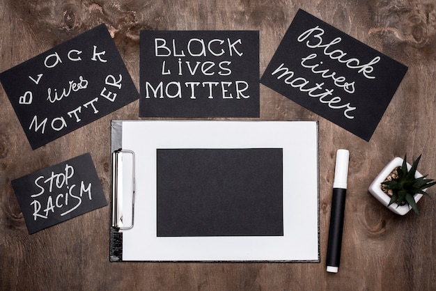 Top view of black lives matter cards with pen and clipboard