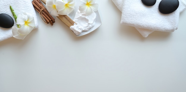 Top view of black stones and accessories for massages on white