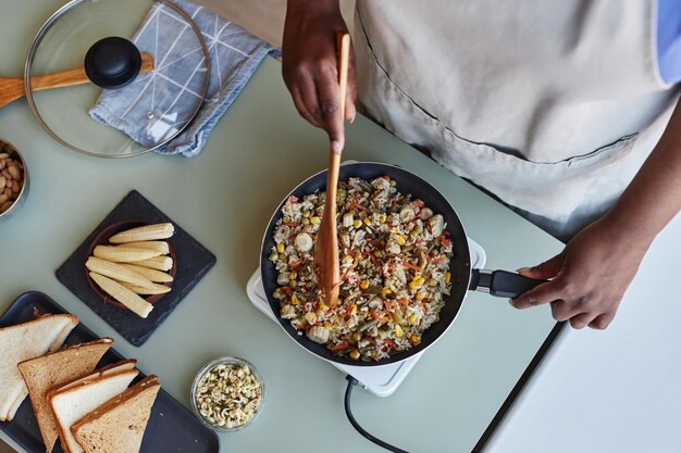 Top view of black woman cooking on kitchen counter