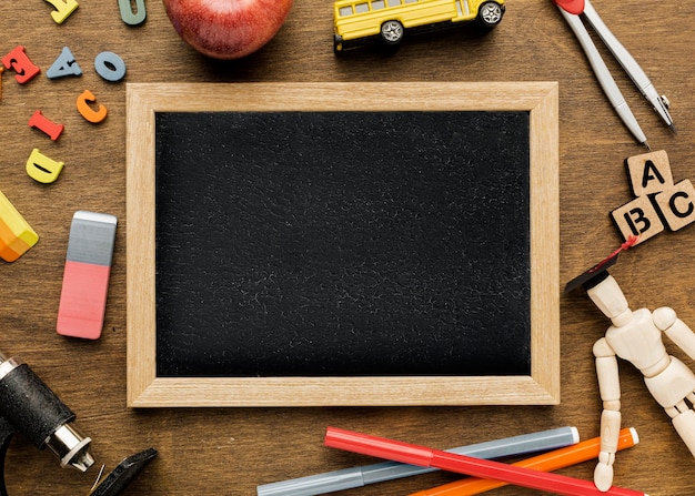 Top view of blackboard with letters and apple