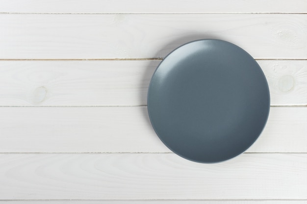 Top view of blank dish on a wood background with copy space