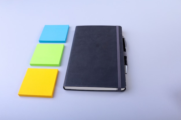 Photo top view of blank notebook and empty note sticker on a blue . back to school . flat lay