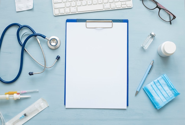 Top view of blank paper for writing doctor prescription. Stethoscope and medical attributes. 