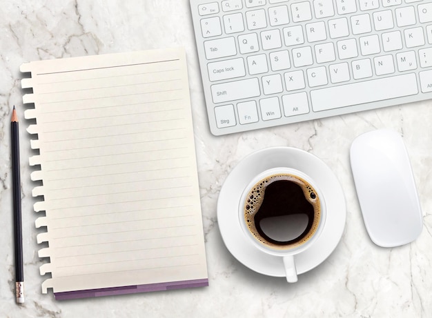 Top view blank paperpencilkeyboard and coffee mug on marble background