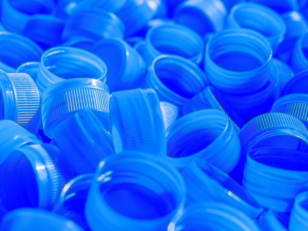 Top view Blue plastic bottle capsRecycling collection and production processing plastic bottle caps