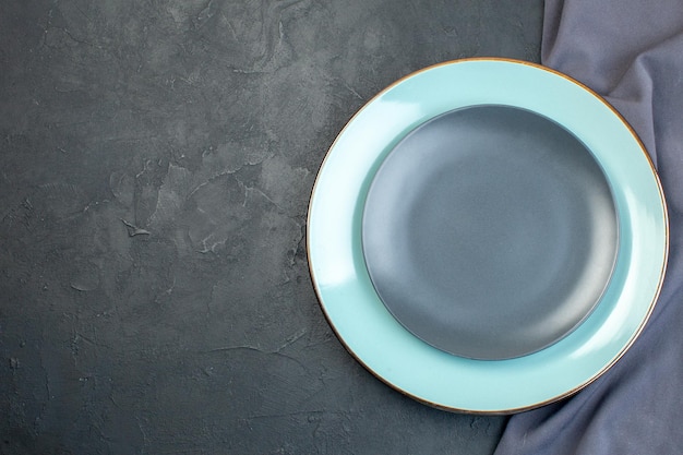 Top view blue plate with gray plate on dark background silverware diner colourful femininity hunger ladies grace cutlery