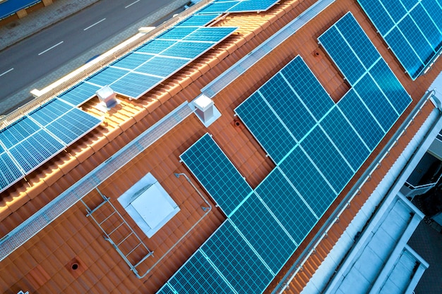 Top view of blue solar photo voltaic panels system on apartment building roof top. Renewable ecological green energy production .