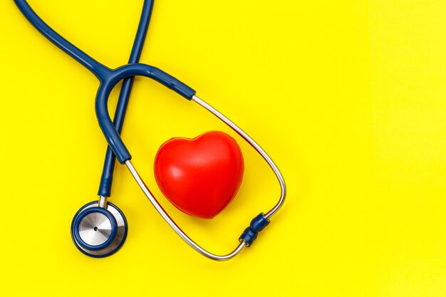 Photo top view blue stethoscope and red heart