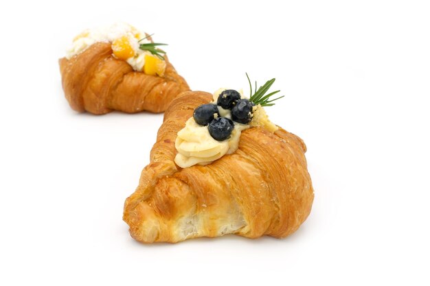 Top view blueberry croissant and mango croissant on white background