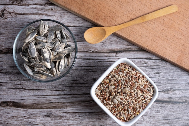 Top view of a board bowl with sunflower seeds and bowl with seed mixture