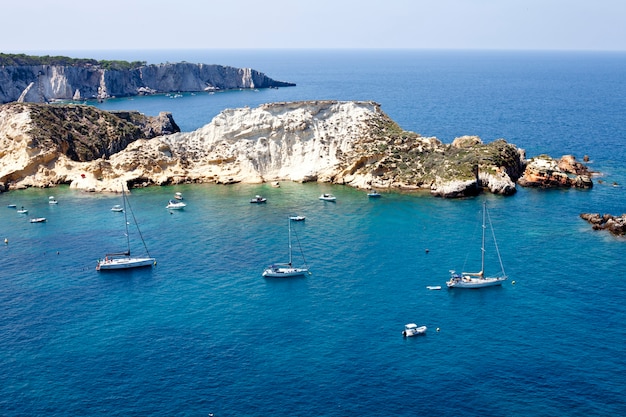 Top view on boats near a rock stone coast