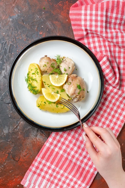 Top view boiled chicken with cooked potatoes greens and lemon on dark background cuisine dish color food dinner sauce calorie meat