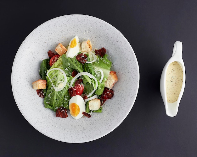 Top view of Boiled egg and ham with green cos lettuce salad isolated on black background