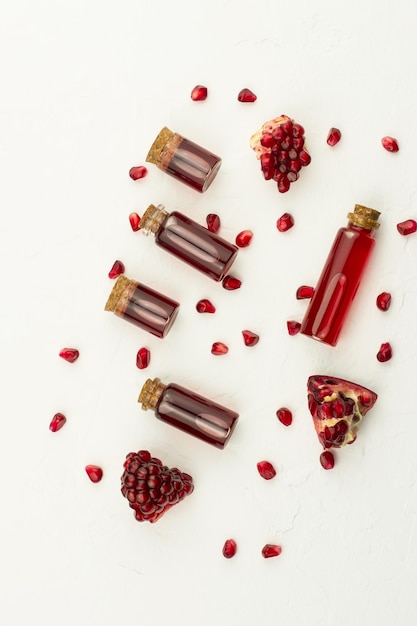 Top view of bottles with a cork lid with pomegranate cosmetic for natural skin care. closeup.