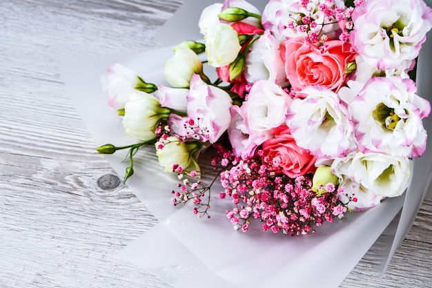 Top view of bouquet of flowers on white wooden background. copy space for text, holiday concept, greeting card. cover