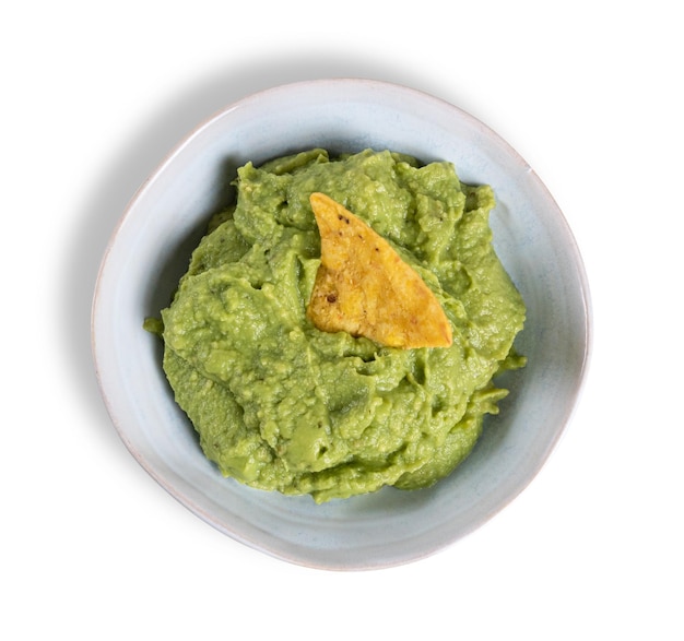 Top view of a bowl with guacamole and nachos isolated on the white background