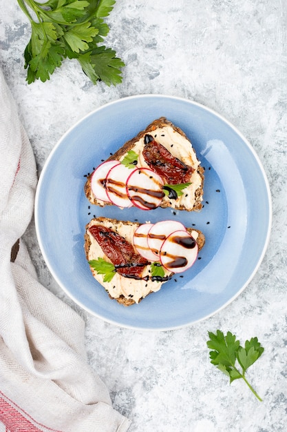 Top view on breakfast meal consisting in toast with hummus