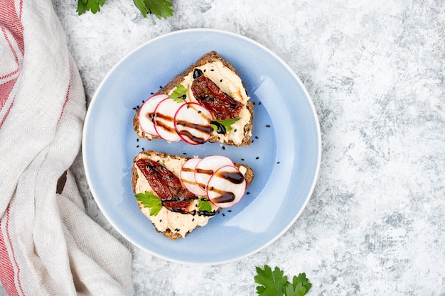 Top view on breakfast meal consisting in toast with hummus