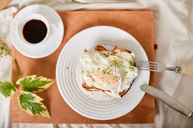 トップ ビュー白いベッド シーツで朝食おはようトーストとポーチドエッグ コーヒー