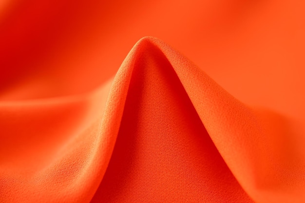 Top view of bright orange fabric background cotton cloth texture crumpled pattern for backdrop