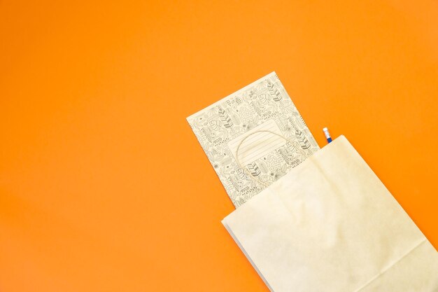 Top view brown paper shopping bag on colourful background mockup of blank brown paper shopping bag and copy space flat lay