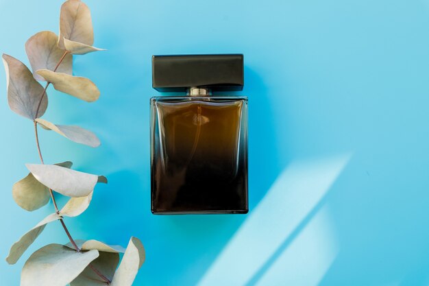 Top view of brown perfume bottle with plant