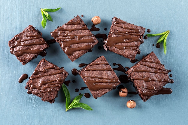 Top view of brownies with hazelnuts and mint