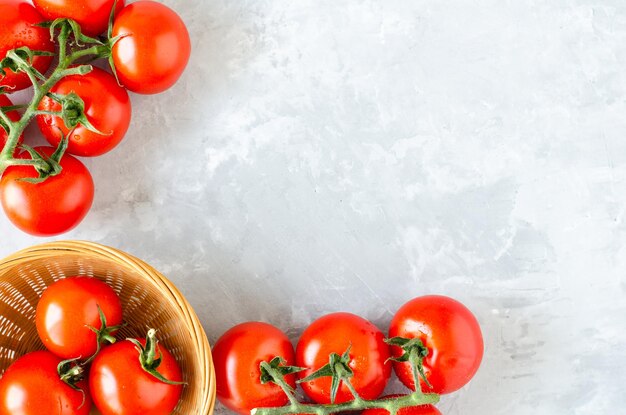 Top view of bunch of fresh tomatoes on grey texture