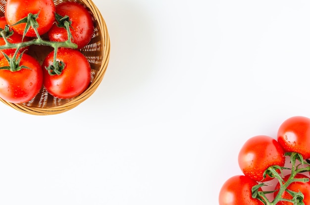 Top view of bunch of fresh tomatoes on white background