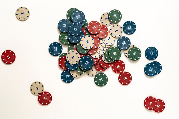 A top view bunch of poker chips drop on colorful table, winning the holdem in casino