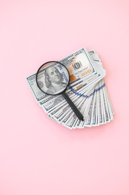 Top view of bundle of 100 dollar bill on pink background Business concept with copy space