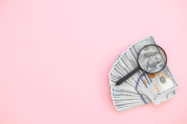 Top view of bundle of 100 dollar bill on pink background Business concept with copy space