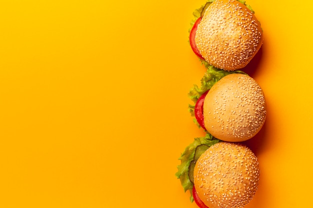 Top view burgers on orange background